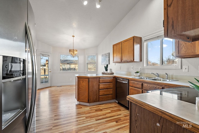 81 N Mirage St, Nampa, ID 83651 - kitchen featuring a sink, light wood-type flooring, a peninsula, stainless steel appliances, and lofted ceiling