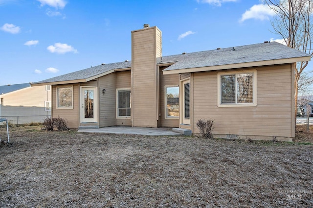 81 N Mirage St, Nampa, ID 83651 - rear view of house featuring a patio, fence, and a chimney