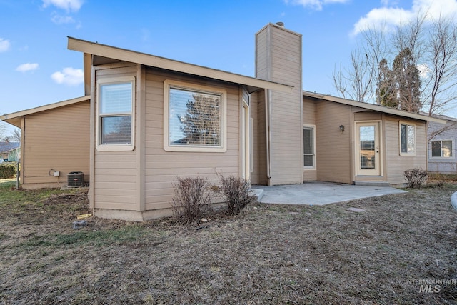 81 N Mirage St, Nampa, ID 83651 - back of property with cooling unit, a patio, and a chimney
