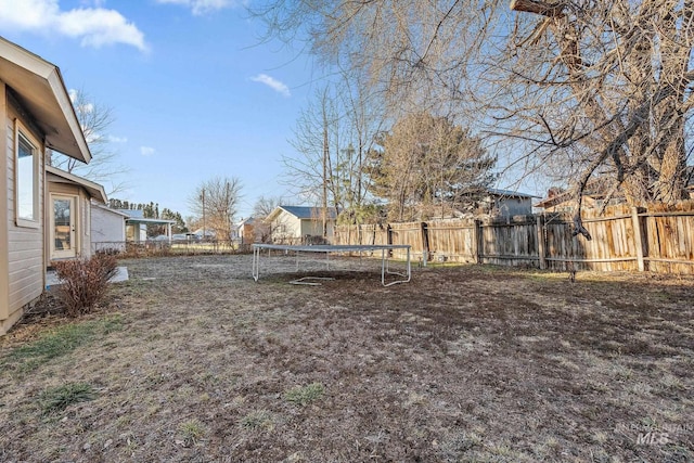 81 N Mirage St, Nampa, ID 83651 - view of yard featuring a trampoline and a fenced backyard
