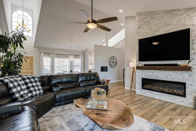 10551 W Deep Canyon Dr, Star, ID 83669 - living room with high vaulted ceiling, ceiling fan, wood finished floors, a fireplace, and plenty of natural light