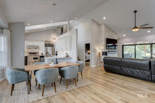 10551 W Deep Canyon Dr, Star, ID 83669 - dining space featuring high vaulted ceiling, ceiling fan, light wood-style floors, recessed lighting, and a chandelier