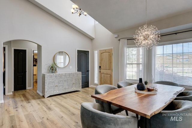 10551 W Deep Canyon Dr, Star, ID 83669 - dining area featuring a chandelier, arched walkways, healthy amount of natural light, and high vaulted ceiling