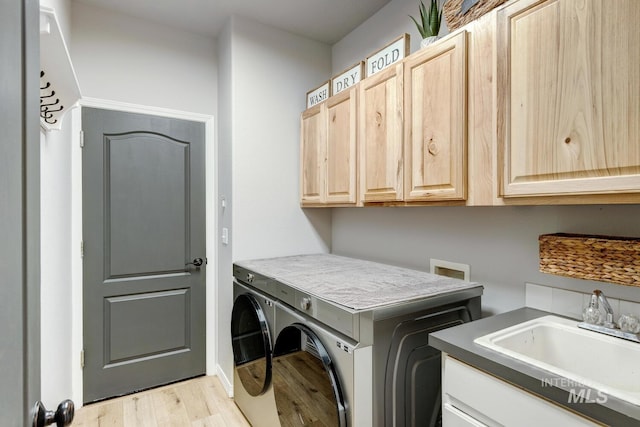 10551 W Deep Canyon Dr, Star, ID 83669 - laundry area with cabinet space, washing machine and clothes dryer, and light wood-style floors