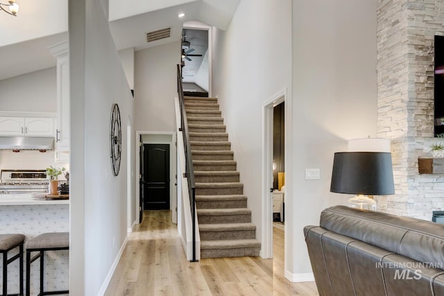 10551 W Deep Canyon Dr, Star, ID 83669 - staircase with high vaulted ceiling, wood finished floors, a ceiling fan, and recessed lighting