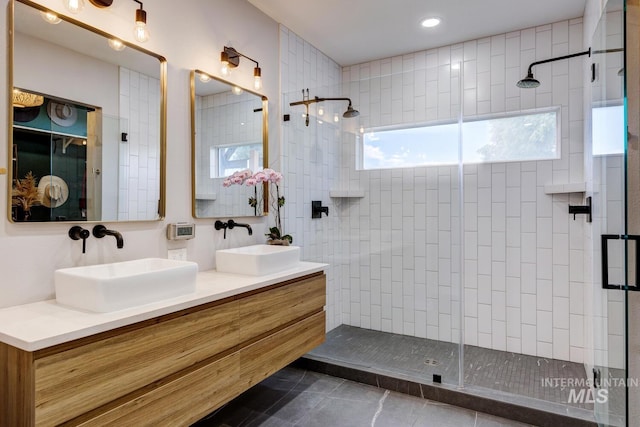 10551 W Deep Canyon Dr, Star, ID 83669 - bathroom with a tile shower, tile patterned floors, and double vanity