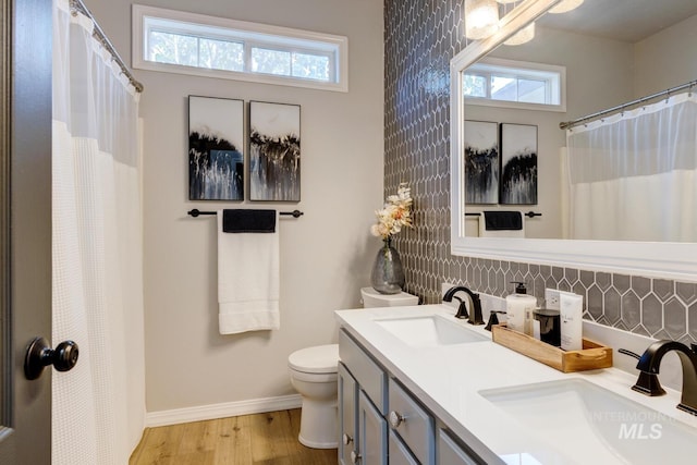 10551 W Deep Canyon Dr, Star, ID 83669 - bathroom with wood finished floors, double vanity, decorative backsplash, and curtained shower