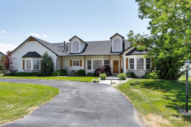 10551 W Deep Canyon Dr, Star, ID 83669 - cape cod house featuring a front lawn, curved driveway, board and batten siding, and a shingled roof
