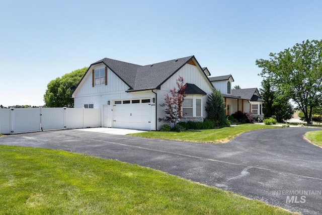10551 W Deep Canyon Dr, Star, ID 83669 - view of side of home featuring a gate, board and batten siding, driveway, and roof with shingles