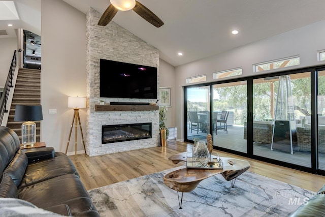 10551 W Deep Canyon Dr, Star, ID 83669 - living area with ceiling fan, high vaulted ceiling, wood finished floors, a fireplace, and stairs