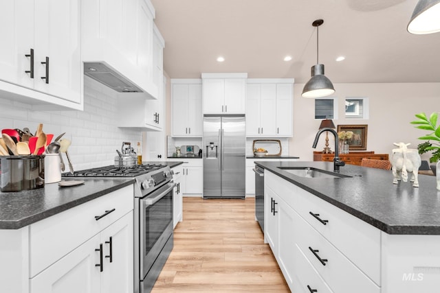 10179 Silversun St, Nampa, ID 83687 - kitchen with stainless steel appliances, a sink, dark countertops, recessed lighting, and backsplash