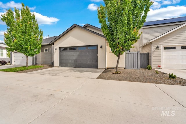 10179 Silversun St, Nampa, ID 83687 - view of front of house with concrete driveway, an attached garage, and stucco siding