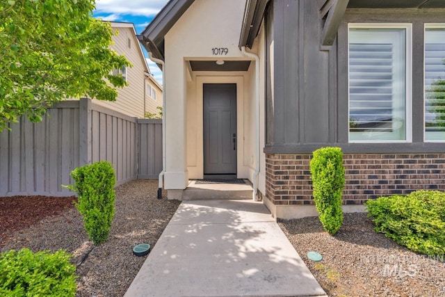 10179 Silversun St, Nampa, ID 83687 - doorway to property featuring brick siding and board and batten siding
