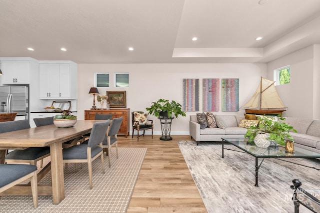 10179 Silversun St, Nampa, ID 83687 - living room with recessed lighting, light wood-type flooring, baseboards, and a raised ceiling