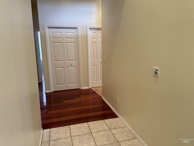 hall featuring light tile patterned flooring