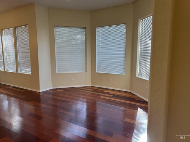 spare room featuring dark wood-type flooring