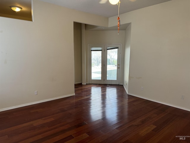 empty room featuring ceiling fan and dark hardwood / wood-style flooring