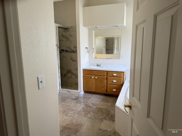 bathroom featuring independent shower and bath and vanity