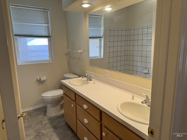 bathroom featuring a healthy amount of sunlight, vanity, and toilet