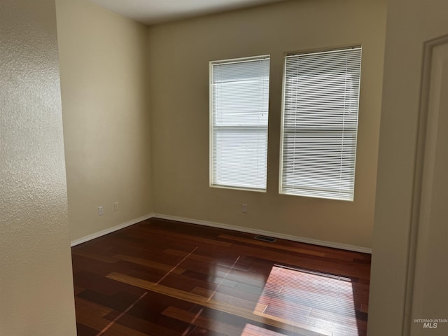 empty room featuring dark wood-type flooring