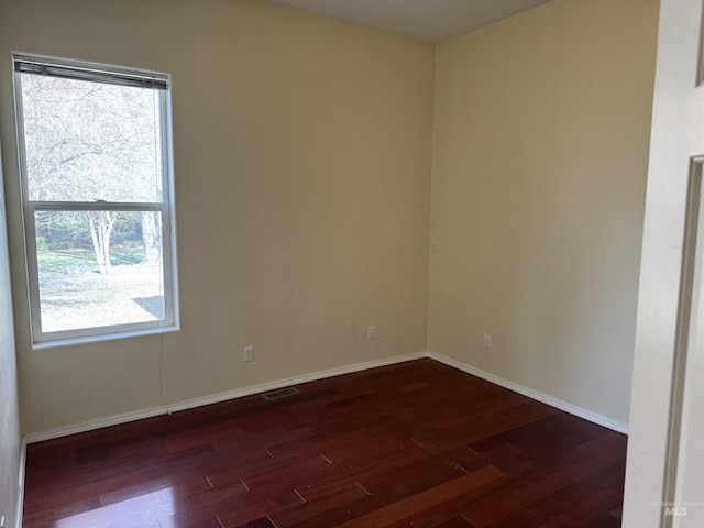 unfurnished room featuring dark wood-type flooring