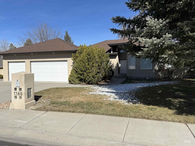 view of front facade with a front yard and a garage