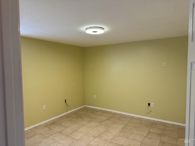 unfurnished room featuring a textured ceiling