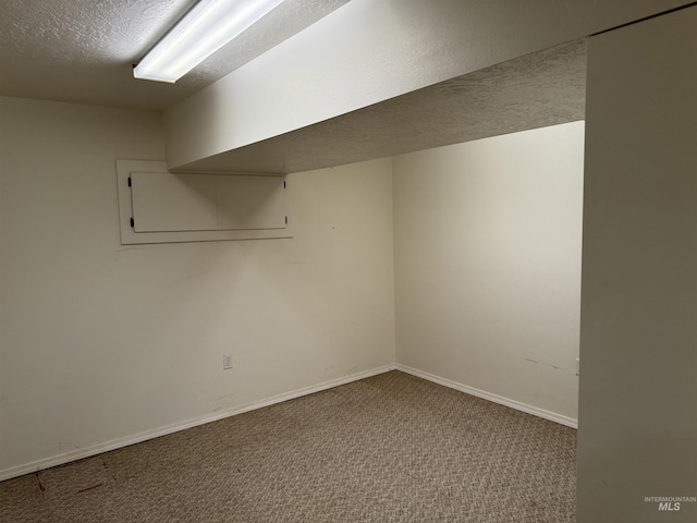 basement with a textured ceiling and carpet floors