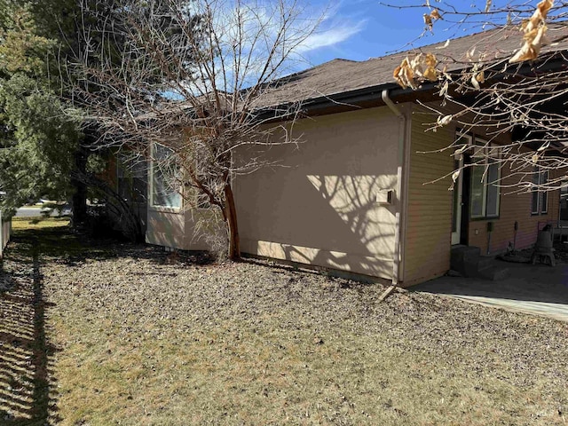 view of side of home featuring a patio area