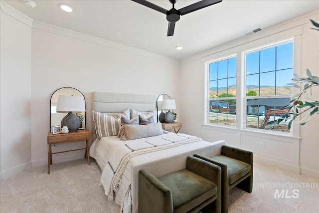 bedroom with baseboards, visible vents, crown molding, and light colored carpet