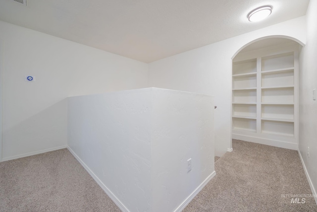 12476 W Kempshire Ct, Star, ID 83669 - hallway with carpet and arched walkways