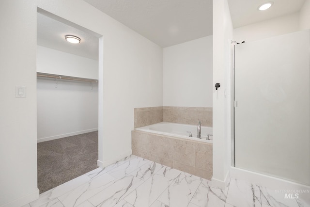 12476 W Kempshire Ct, Star, ID 83669 - full bath with a garden tub, a stall shower, a spacious closet, marble finish flooring, and recessed lighting