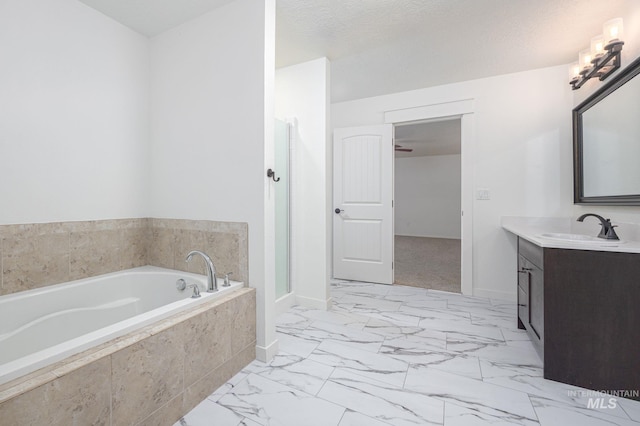 12476 W Kempshire Ct, Star, ID 83669 - bathroom with vanity, a garden tub, marble look tiles, and a shower with shower door