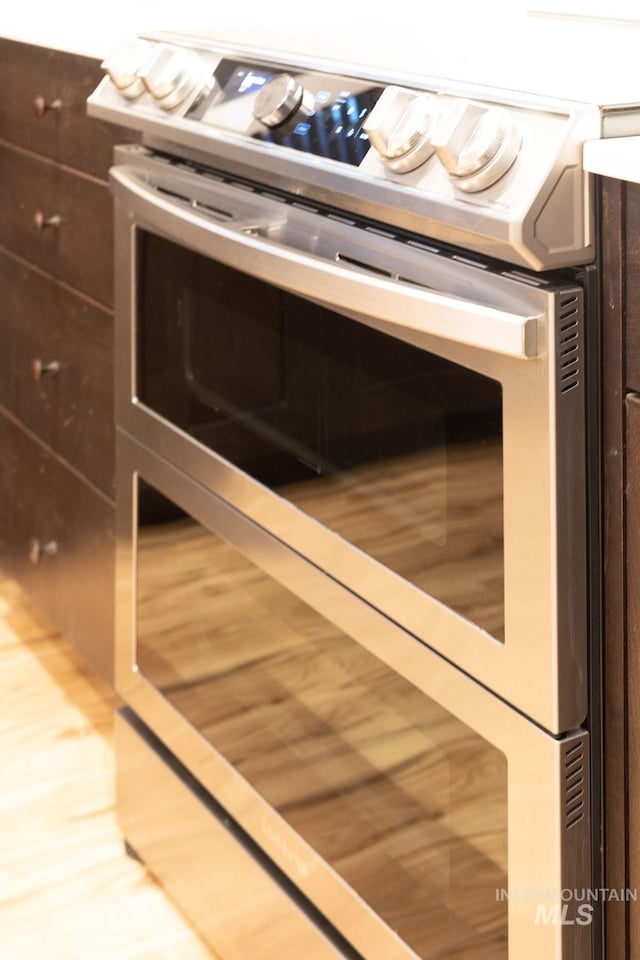 12476 W Kempshire Ct, Star, ID 83669 - kitchen view of double oven range and dark brown cabinetry