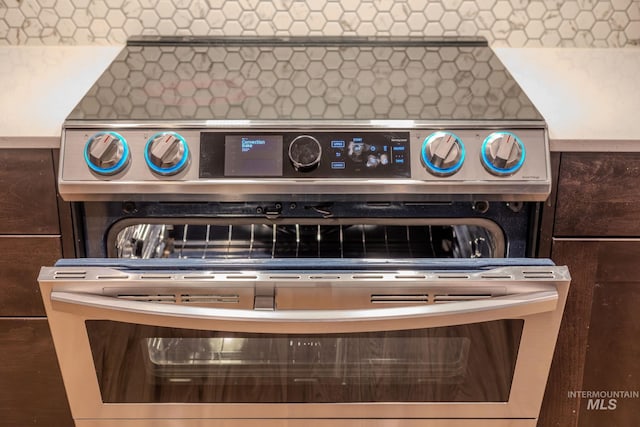 12476 W Kempshire Ct, Star, ID 83669 - kitchen view of decorative backsplash and stainless steel range with electric stovetop