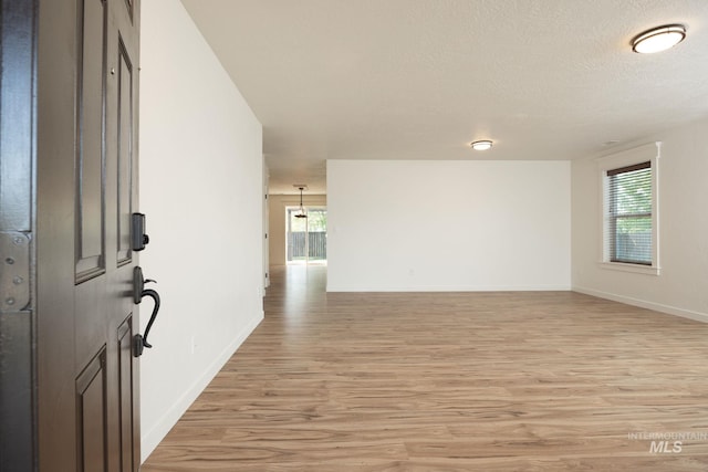 12476 W Kempshire Ct, Star, ID 83669 - spare room featuring light wood-style flooring and a textured ceiling