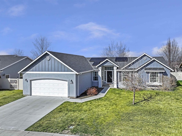 ranch-style home featuring driveway, a front lawn, roof mounted solar panels, board and batten siding, and an attached garage