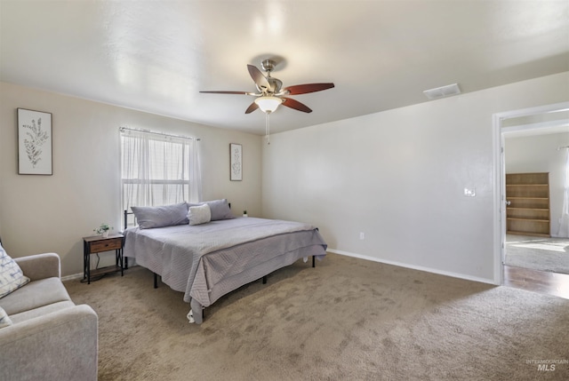 bedroom with visible vents, a ceiling fan, baseboards, and carpet floors