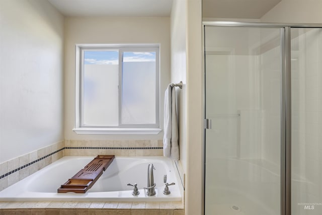 full bath featuring a garden tub and a stall shower