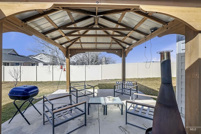 view of patio with a gazebo, a grill, and a fenced backyard