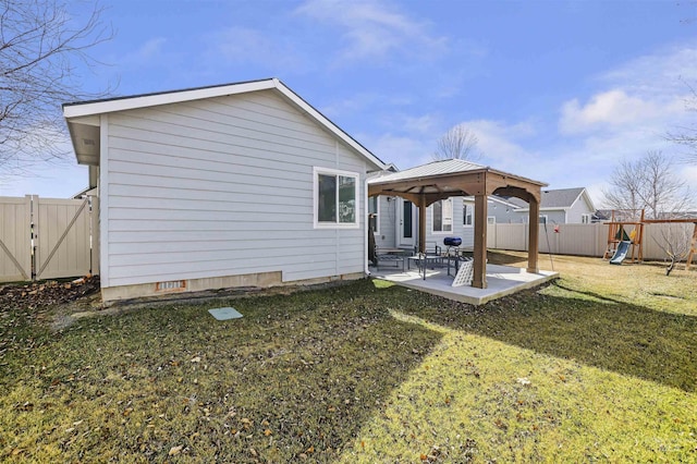 rear view of property with a gate, a patio, a fenced backyard, a gazebo, and a yard