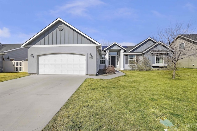 view of front of home with fence, driveway, a front lawn, a garage, and board and batten siding