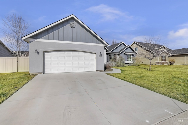 view of front of home with a front yard, fence, driveway, a garage, and board and batten siding