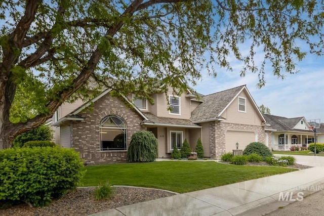 628 E Trinidad Dr, Meridian, ID 83642 - traditional-style house with brick siding, concrete driveway, a front yard, and a garage