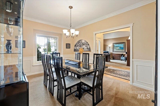 628 E Trinidad Dr, Meridian, ID 83642 - carpeted dining space with crown molding, a chandelier, wainscoting, and a decorative wall