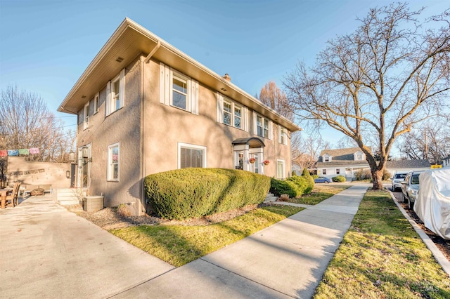 view of side of home with stucco siding