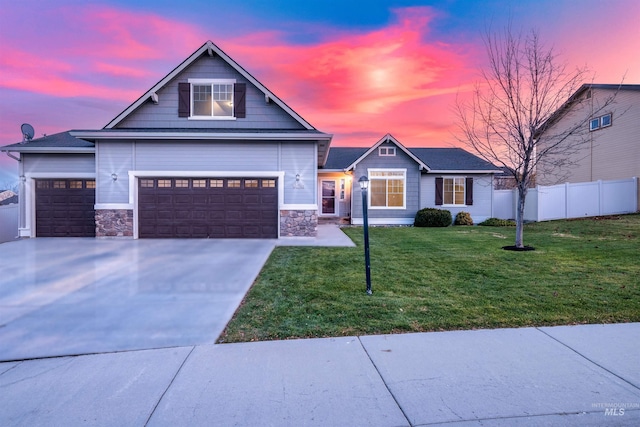 view of front of house featuring a yard and a garage