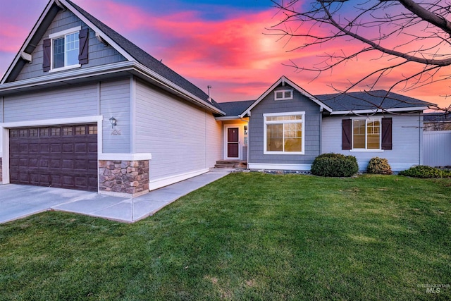 view of front of house with a yard and a garage