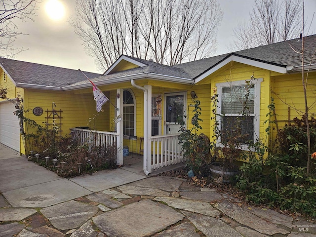 view of front of property featuring a garage and covered porch