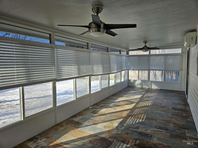 unfurnished sunroom featuring ceiling fan and a wall unit AC